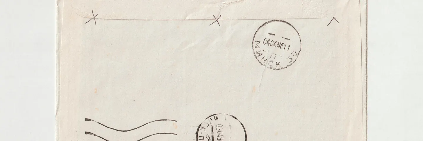 A mailed envelope with postage and postmarks